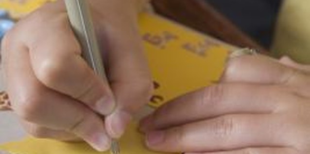 Jupiterimages/Comstock/Getty Images When scrapbooking for your teenage daughter, invite her input.