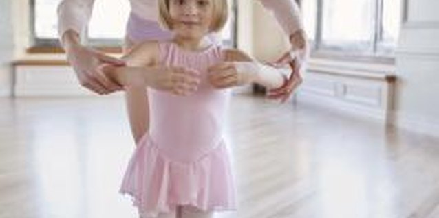 Jupiterimages/Creatas/Getty Images With some help, your prima ballerina can master the basic ballet positions.