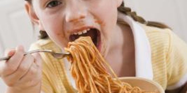 Jupiterimages/Comstock/Getty Images Teach table manners during preschool years.