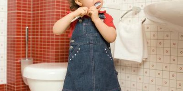 Thinkstock Images/Comstock/Getty Images Toddlers should get help with tooth brushing from an adult.