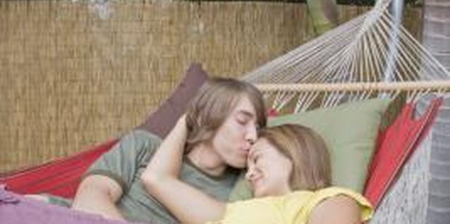 Jupiterimages/Brand X Pictures/Getty Images Touching your friend can signal to him that you want to be closer.