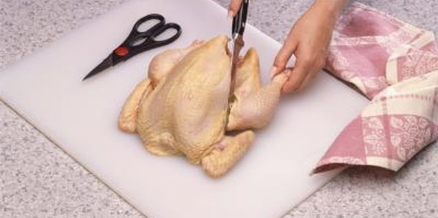 Jupiterimages/Comstock/Getty Images Cut a whole chicken into smaller pieces for fast cooking.