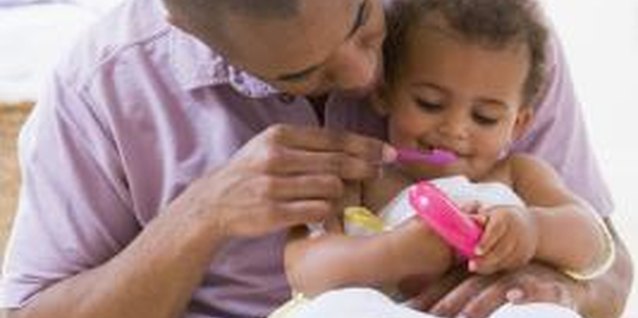BananaStock/BananaStock/Getty Images Once new teeth have erupted, a soft toothbrush can be introduced.