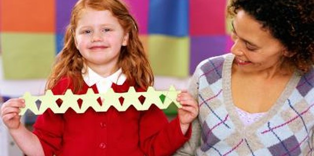 Katy McDonnell/Digital Vision/Getty Images Make some paper stars to hang in her window.