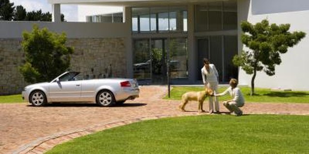 Goodshoot/Goodshoot/Getty Images A house looks much better if the grass grows right up to the edge of the driveway.
