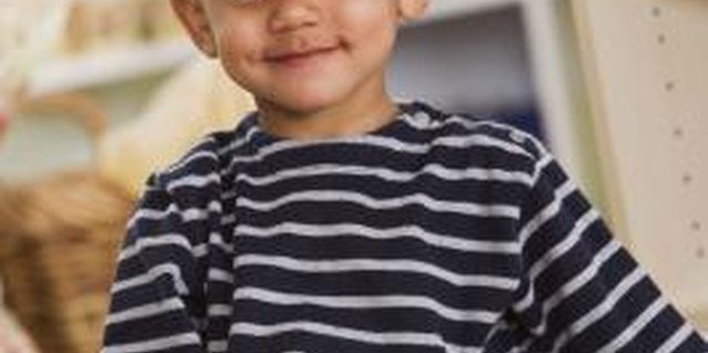 Jupiterimages/Comstock/Getty Images Playing with toys help children improve fine motor skills.