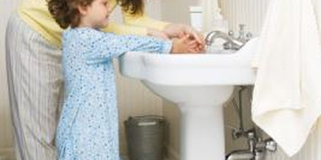 Jupiterimages/Creatas/Getty Images Insisting your tot constantly wash her hands is a sign of overprotective parenting.
