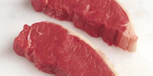 Polka Dot Images/Polka Dot/Getty Images Buy steaks and dice them yourself to save money.