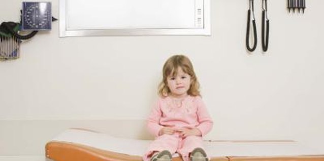 Jupiterimages/Comstock/Getty Images Prepare your child for her upcoming surgery and read books about the subject.
