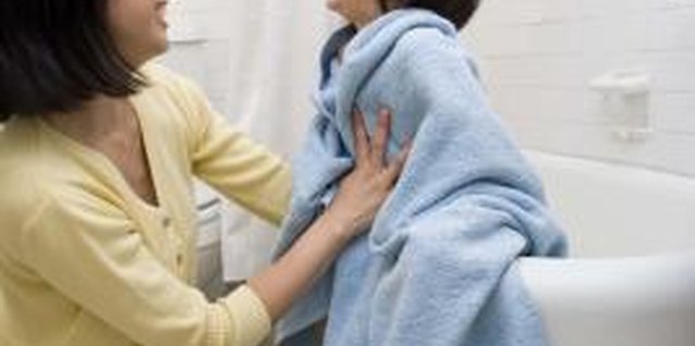 Jupiterimages/Creatas/Getty Images Stay in the bathroom while he showers alone.