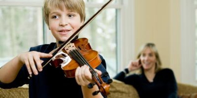 Jupiterimages/Photos.com/Getty Images Violin lessons include both instructor and parent involvement.
