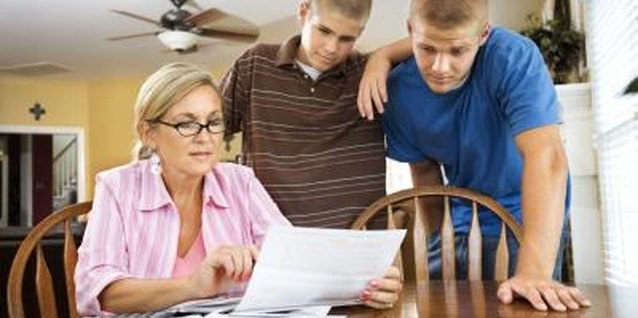 Jupiterimages/Comstock/Getty Images You may also share your own budget to help your teens learn the ropes.