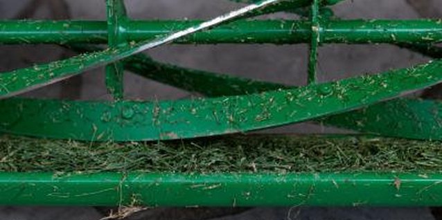 Jupiterimages/Photos.com/Getty Images Wash grass clippings off mowers before storing them to prevent rust.
