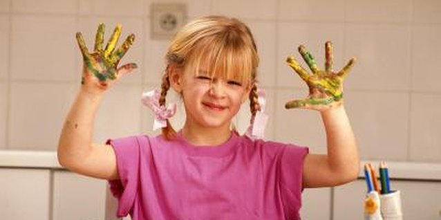 David De Lossy/Digital Vision/Getty Images Tactile defensive children may be fearful of messy activities like finger painting.