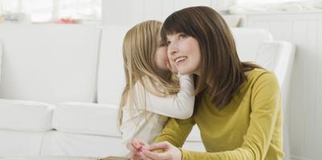 Jupiterimages/Comstock/Getty Images With practice, children learn to whisper.