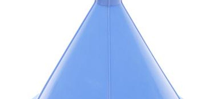 Hemera Technologies/PhotoObjects.net/Getty Images Using a funnel to add oil to a lawn mower prevents messy spills.