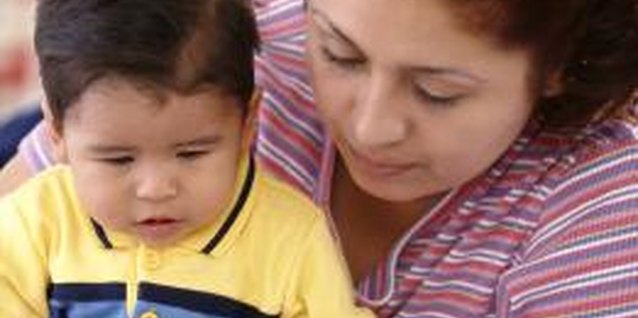 Brand X Pictures/Brand X Pictures/Getty Images Build early literacy skills by reading to your child at an indoor play center.