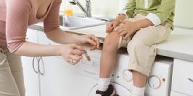 Jupiterimages/Creatas/Getty Images Properly treat a cut or abrasion to help prevent a scar.