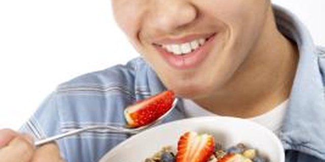 BananaStock/BananaStock/Getty Images Carbohydrates give your teen the energy he needs to get through his busy day.
