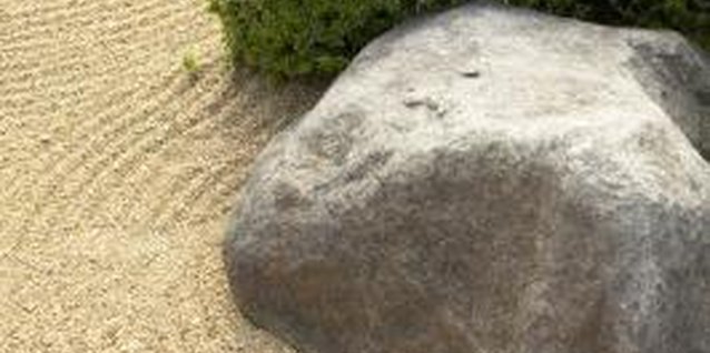 Jupiterimages/Photos.com/Getty Images Gravel-coated focal points don't look the same with grass poking through.
