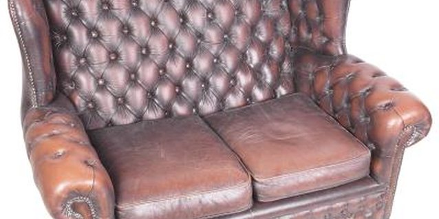 Hemera Technologies/PhotoObjects.net/Getty Images Dark leather settees with rolled arms add visual weight and antique flair.