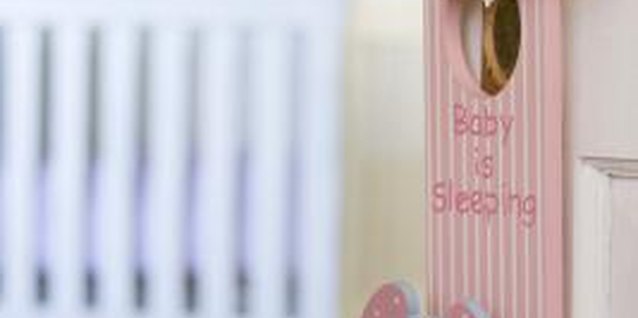 Jupiterimages/Pixland/Getty Images Furnishing a nursery will entail choosing a bed for your baby.