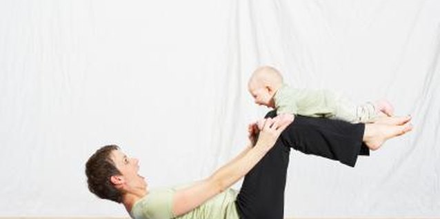 Jupiterimages/Photos.com/Getty Images Strengthening your abdominal wall can be done while exercising with your baby.