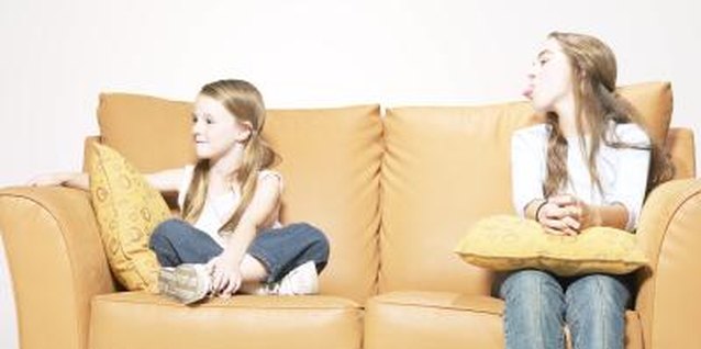 Hemera Technologies/AbleStock.com/Getty Images Petty behavior between siblings can create a miserable family day.
