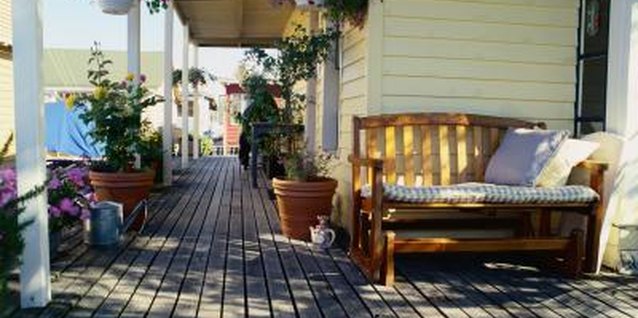 Ryan McVay/Photodisc/Getty Images Protect your deck fully by staining in the cracks.