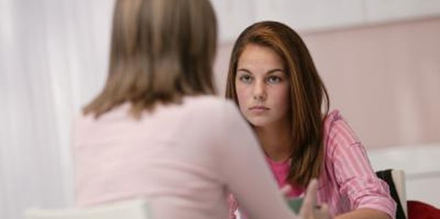 Comstock/Stockbyte/Getty Images Choose a private, calm moment to talk to your daughter.