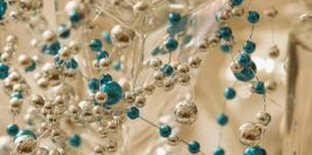 Jupiterimages/Stockbyte/Getty Images Drape a net of shiny baubles over a crystal candlestick for a holiday brunch table.