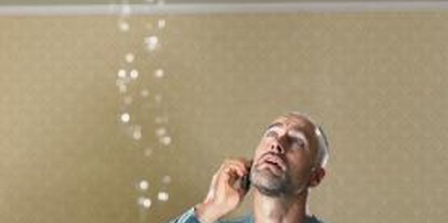 Michael Blann/Digital Vision/Getty Images A leaking tub can ruin the ceiling of the floor below.