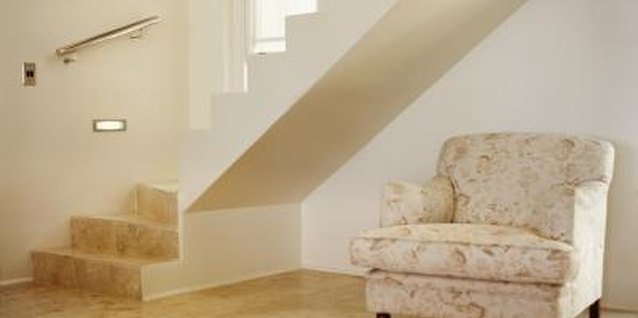 Ciaran Griffin/Stockbyte/Getty Images Stairwells create triangular pockets of space for extra storage when enclosed.