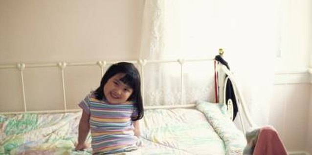 Creatas/Creatas/Getty Images A daybed doubles as play space in a children's bedroom.