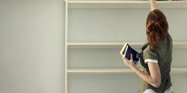 Gary Houlder/Lifesize/Getty Images Display your favorite books on the top shelves and cover the lower half with curtains for storage.