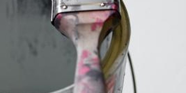 Jupiterimages/Photos.com/Getty Images A thin coat of primer is essential for painting vinyl wallpaper.
