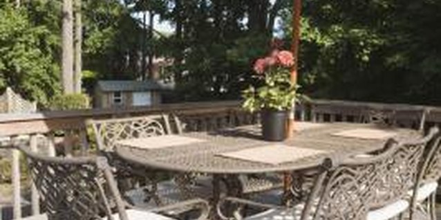 Thinkstock Images/Stockbyte/Getty Images Update a metal dining set with fresh paint and a new umbrella.