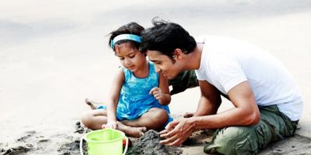 Visage/Stockbyte/Getty Images Build sand castles in the sand box as a class effort.