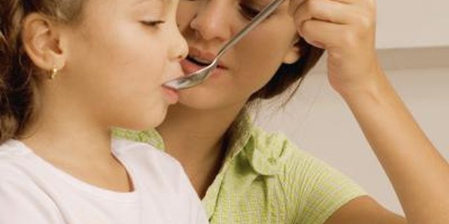 Medioimages/Photodisc/Photodisc/Getty Images Help your child feel relaxed so she doesn't instinctively spit.