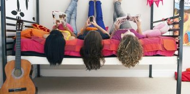 Goodshoot RF/Goodshoot/Getty Images Your teen might use her phone or computer as a means to ignore you.