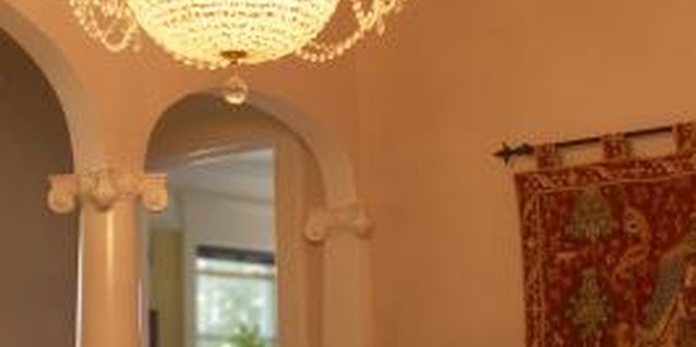 Hemera Technologies/AbleStock.com/Getty Images Tapestries and low-hanging light fixtures direct attention to a tall wall.