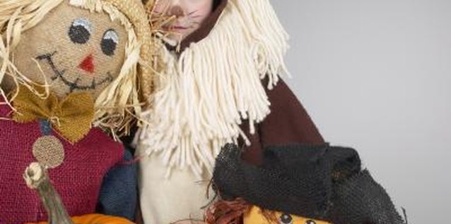 Hemera Technologies/AbleStock.com/Getty Images Dress your child in his favorite scarecrow outfit, using ready-made patterns to keep it simple.