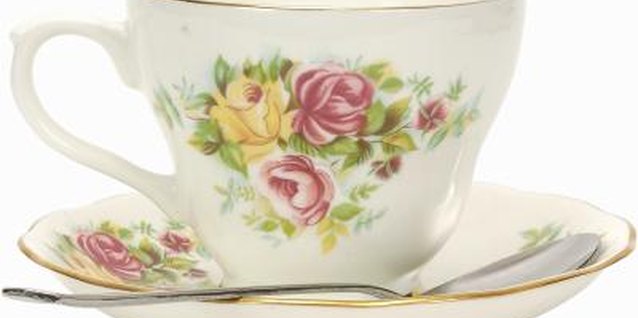 Zedcor Wholly Owned/PhotoObjects.net/Getty Images Teacups add a dainty and whimsical touch to a potted plant.