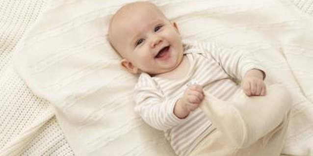 Marc Debnam/Digital Vision/Getty Images Within the first three months, baby develops a social smile.
