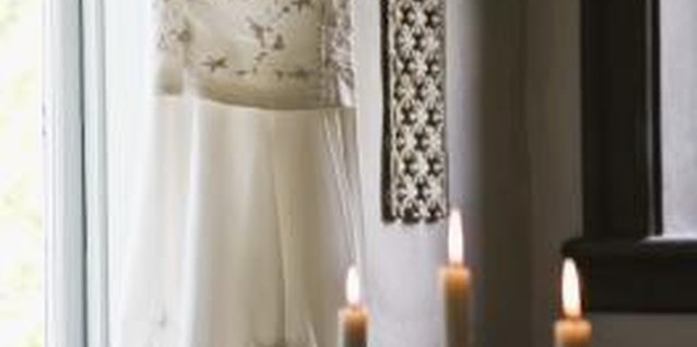 Jupiterimages/BananaStock/Getty Images Hang your wedding gown up prior to your wedding to avoid wrinkles.