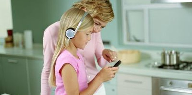 Digital Vision/Digital Vision/Getty Images Staying involved in what your child is doing on her iPod Touch is one way to ensure her safety.