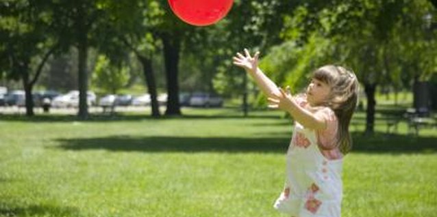Jupiterimages/liquidlibrary/Getty Images Give your child access to balls of different sizes, weights and colors.