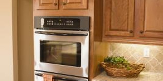 Jupiterimages/Comstock/Getty Images Refacing instead of replacing cabinets can save approximately 50 percent of renovation cost.