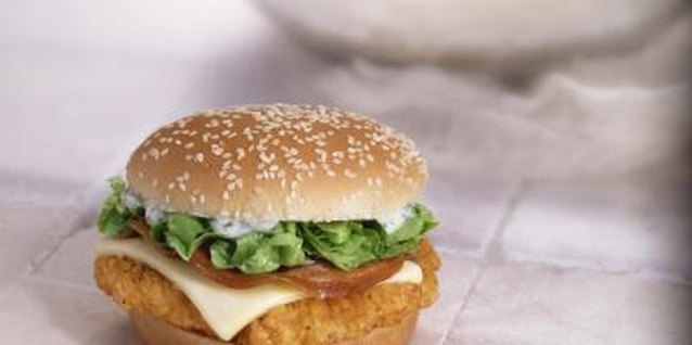 Jupiterimages/Comstock/Getty Images A spicy chicken sandwich can be a whole meal stacked on a bun.
