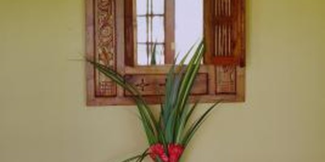 NA/Photos.com/Getty Images A tall floral arrangement adds height and emphasis to a static, symmetrical vignette.